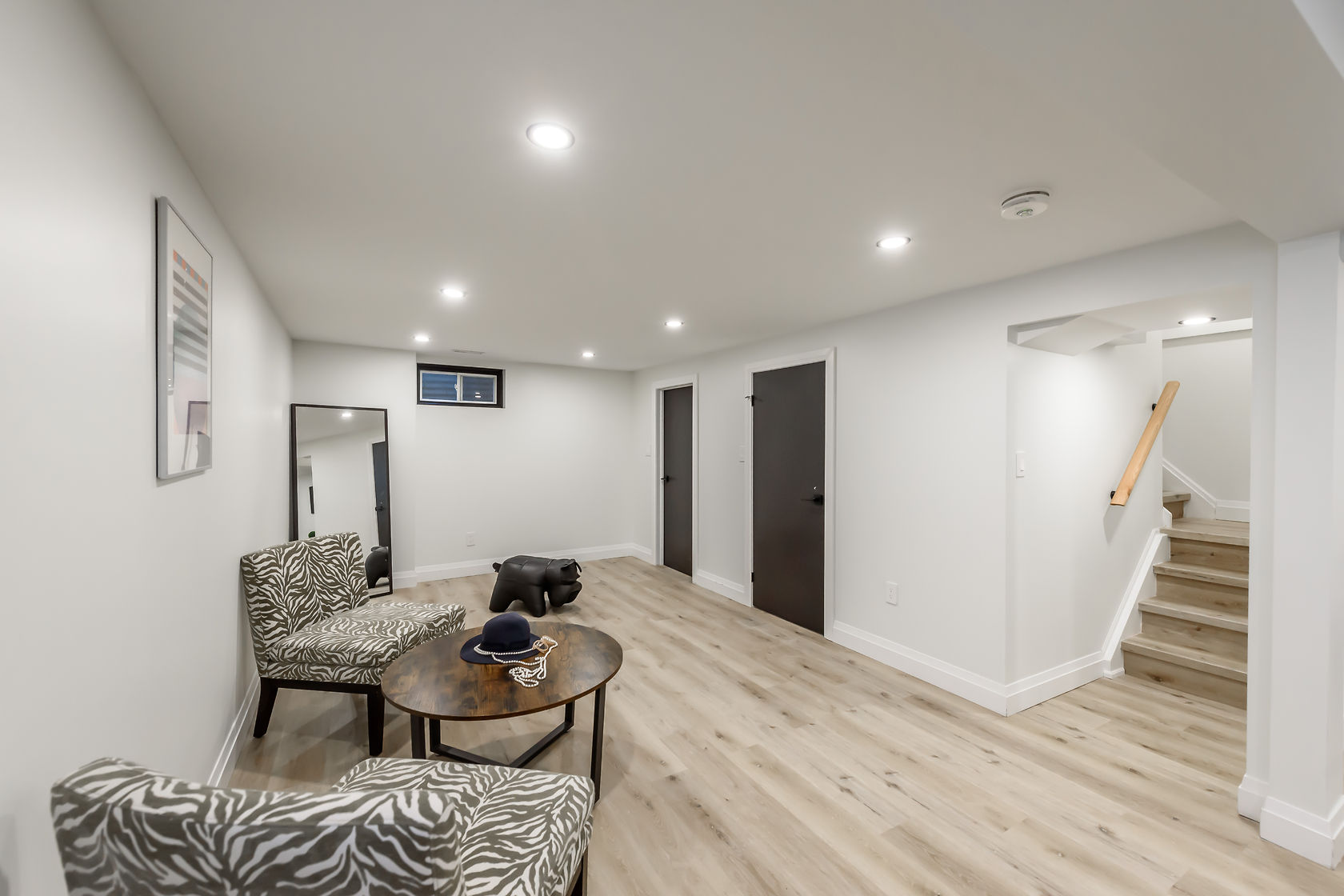 Bright finished basement with excellent staging and wide-angle composition — premium portfolio shot showing complete transformation — Gateshead, Hamilton | MTC Renovations